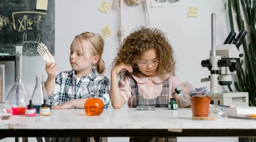 Two girls exploring science.